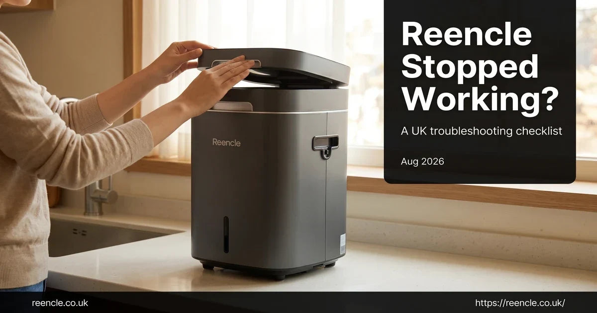 Dark grey Reencle composter on a kitchen counter with hands checking it, part of a UK troubleshooting guide.