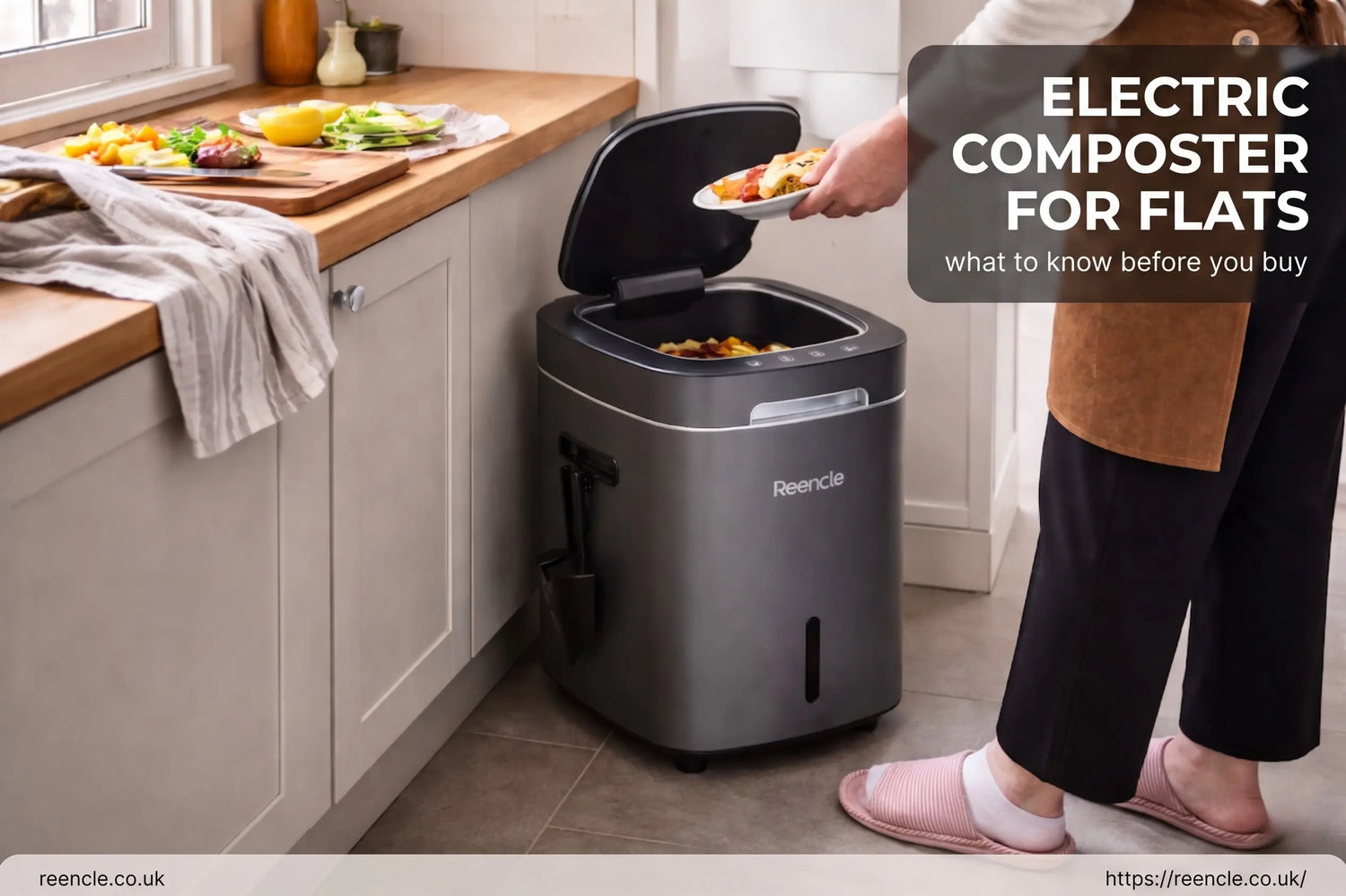 A compact electric food composter on a white kitchen worktop with a hand lifting the lid to add vegetable scraps.